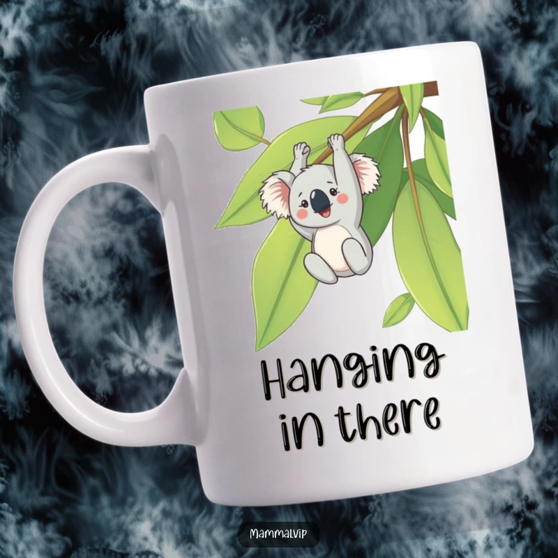 Funny mug with a cheerful koala character hanging upside down from a large eucalyptus leaf, looking content and relaxed.