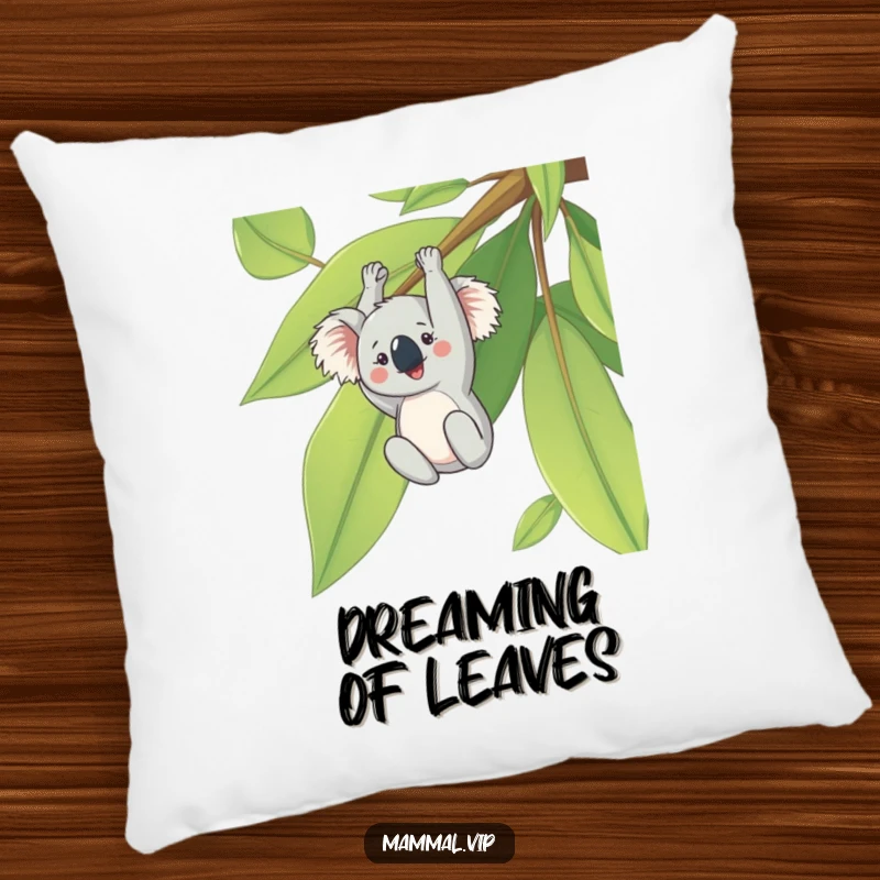 Funny pillow with a cheerful koala character hanging upside down from a large eucalyptus leaf, a cute and comfortable decorative item.