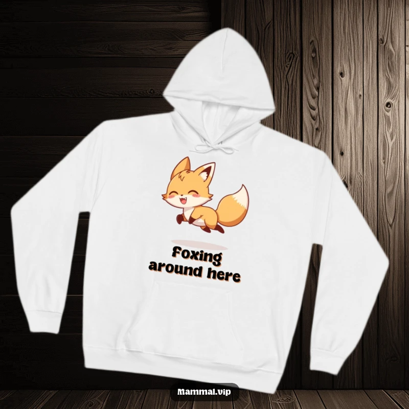 Funny playful fox character gleefully chasing its tail, featured on a warm hoodie, embodying a humorous animal and nature theme.